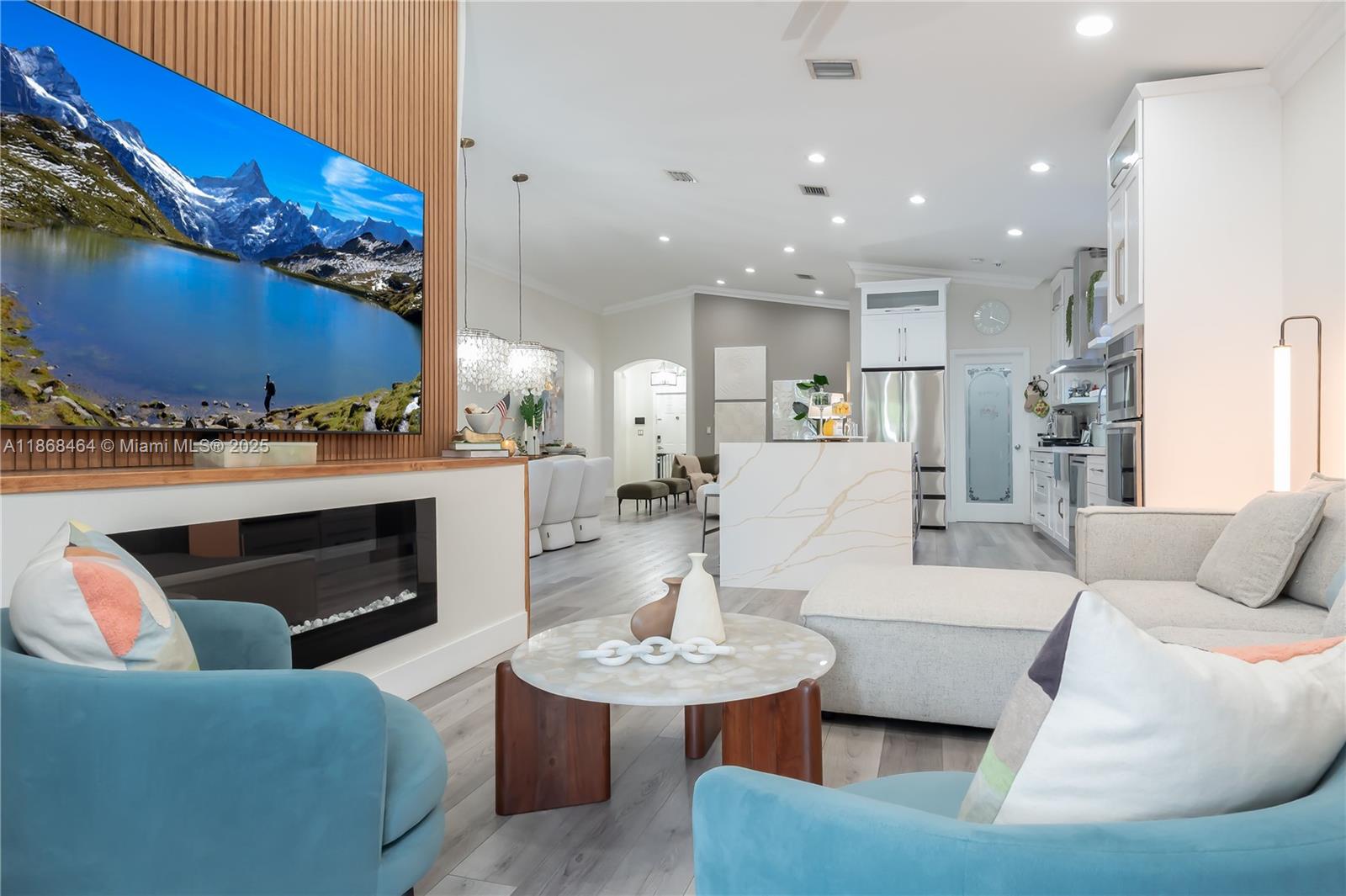 13348 Southwest 52nd Street Miramar, FL 33027 - Photo 18 of 48 a living room with furniture a fireplace and kitchen view