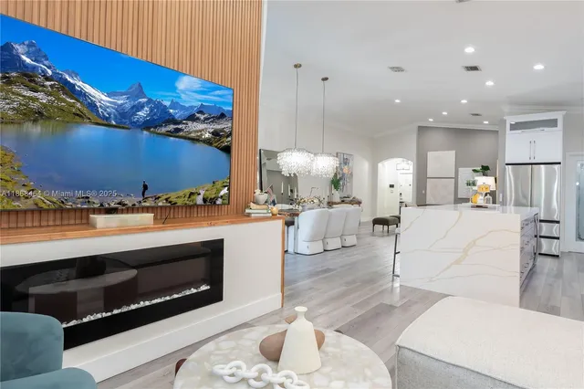 a living room with furniture a fireplace and a flat screen tv