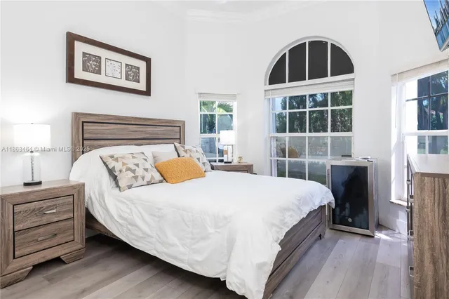 a bedroom with a bed and a painting on the wall