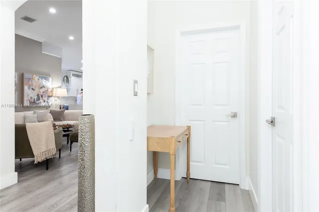 a bedroom with a bed and painting on the wall