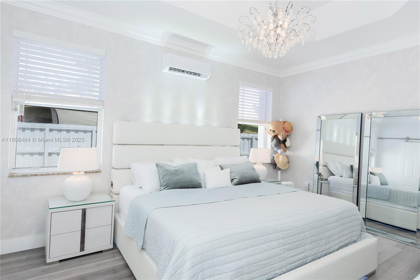 13348 Southwest 52nd Street Miramar, FL 33027 - Photo 29 of 48 a bedroom with a bed and a chandelier