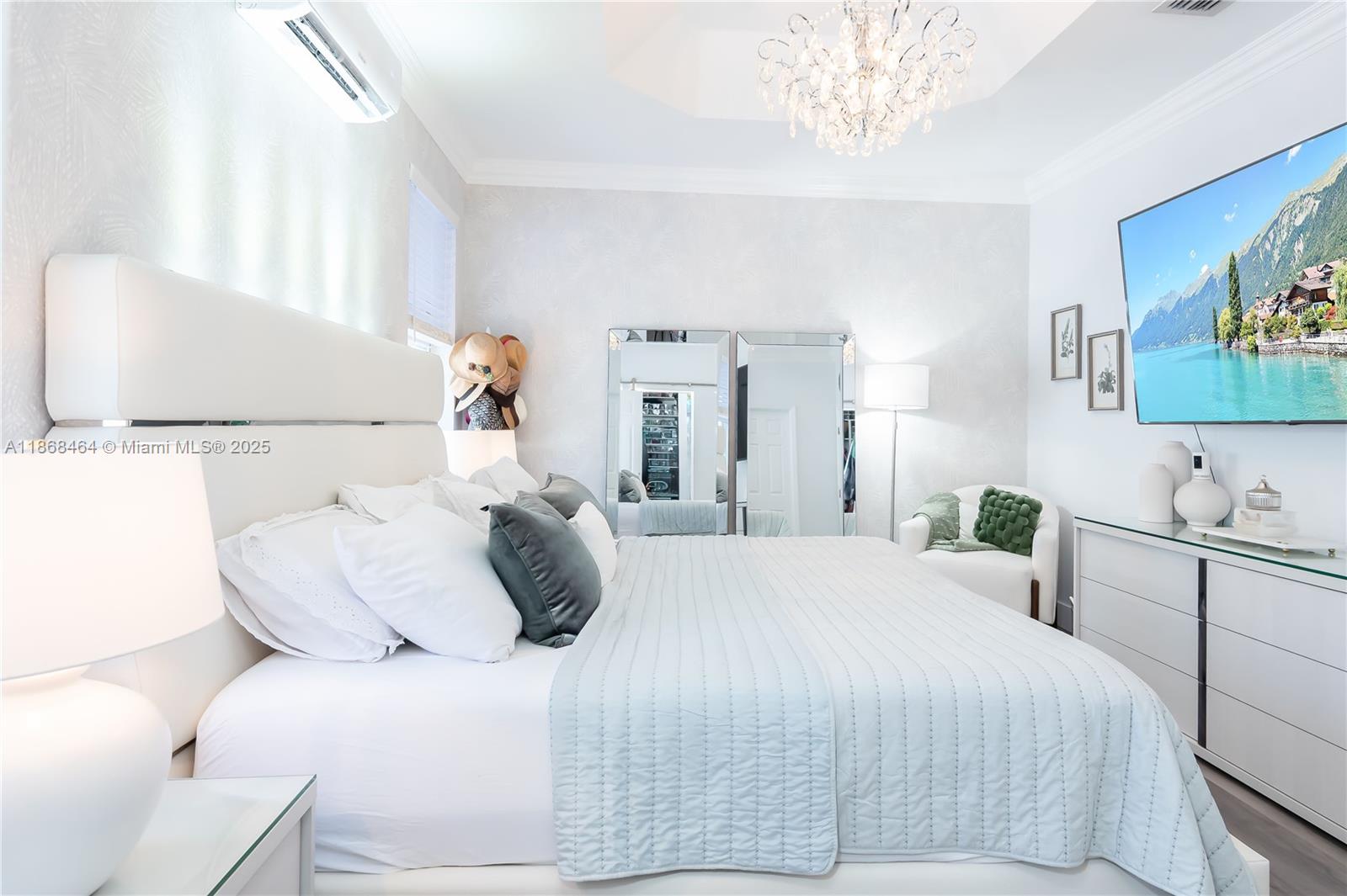 13348 Southwest 52nd Street Miramar, FL 33027 - Photo 31 of 48 a bedroom with a large bed and a chandelier