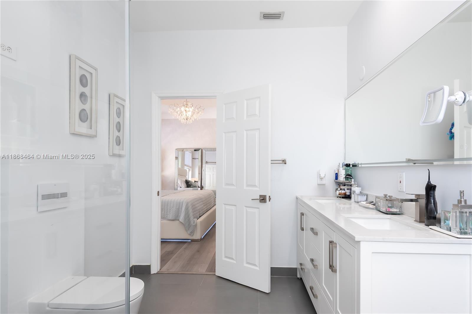 13348 Southwest 52nd Street Miramar, FL 33027 - Photo 32 of 48 a bathroom with a sink a toilet and shower