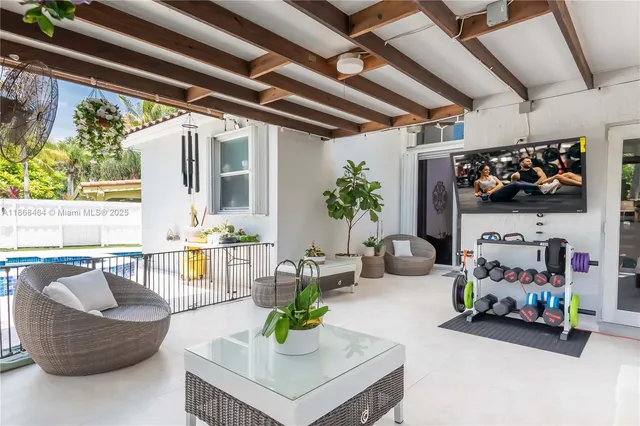 a dining room with chandelier fan and window
