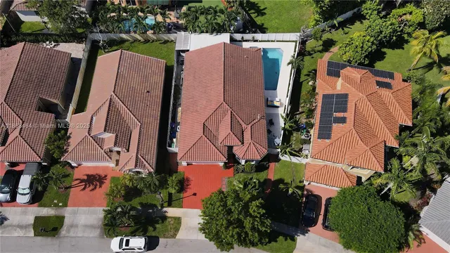 an aerial view of a house with a yard basket ball court and outdoor seating