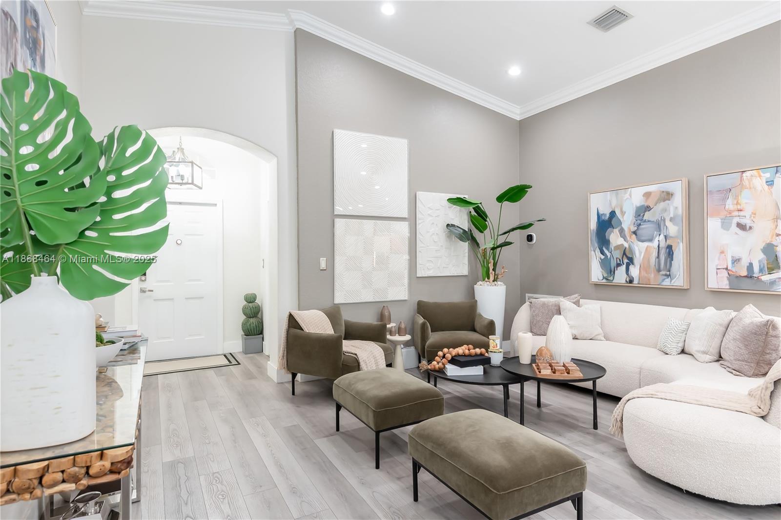 13348 Southwest 52nd Street Miramar, FL 33027 - Photo 8 of 48 a living room with furniture a wooden floor and a potted plant
