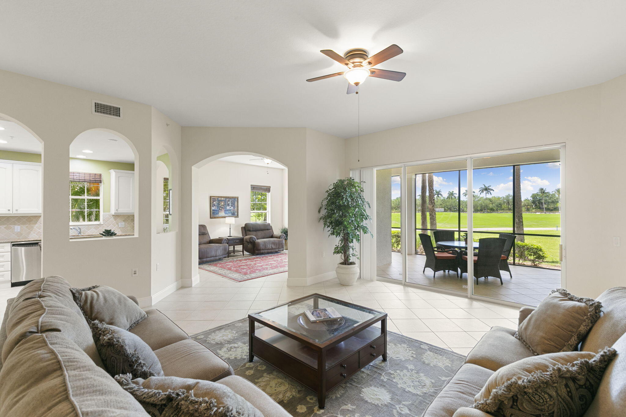 9066 Cascada Way, Unit 101 Naples, FL 34114 - Photo 8 of 51 a living room with furniture and a large window