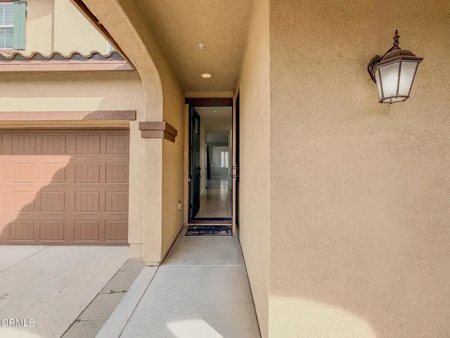 a view of a hallway with wooden floor and cabinet