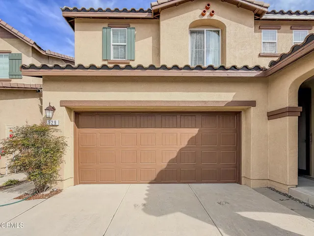 a view of a house with a tree