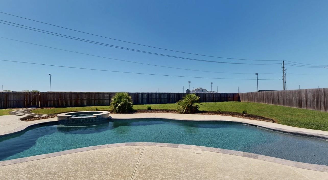 1508 North Blue Bonnet Lane Angleton, TX 77515 - Photo 11 of 11 a view of a backyard with table and chairs
