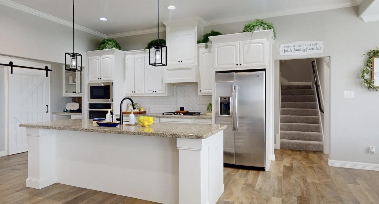 1508 North Blue Bonnet Lane Angleton, TX 77515 - Photo 5 of 11 a kitchen with stainless steel appliances a refrigerator and a stove top oven
