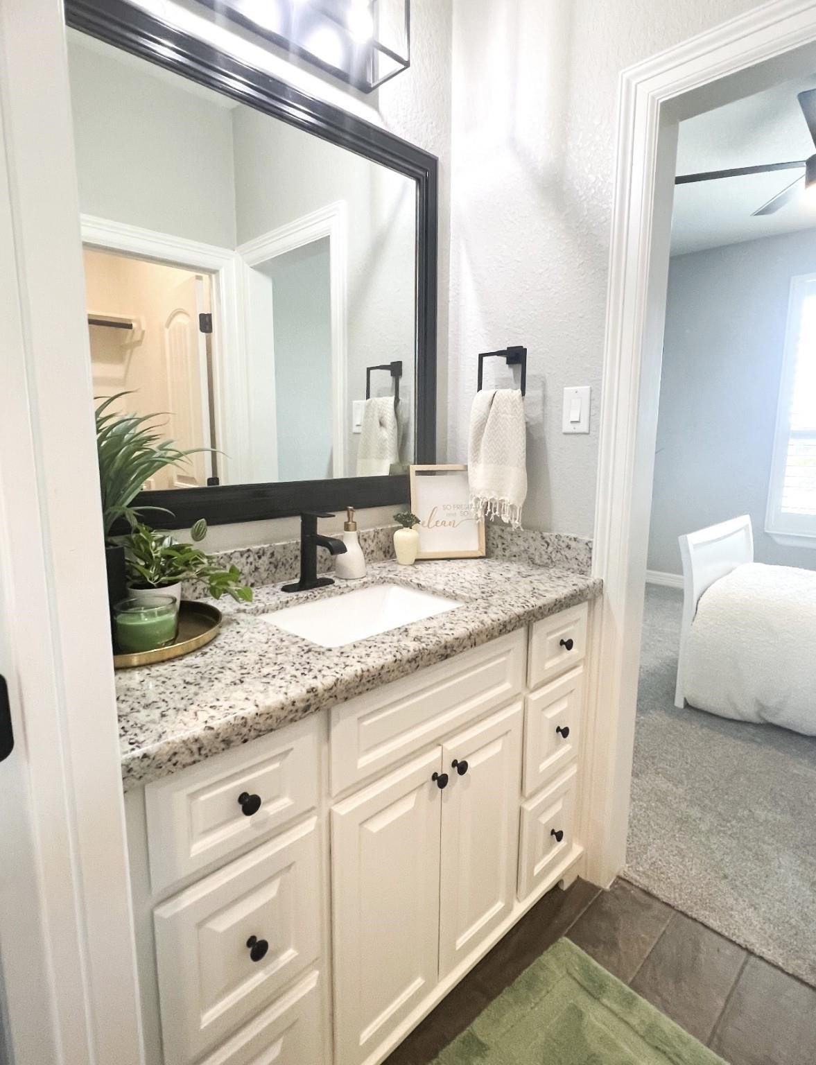 1508 North Blue Bonnet Lane Angleton, TX 77515 - Photo 10 of 11 a bathroom with a granite countertop sink and a mirror