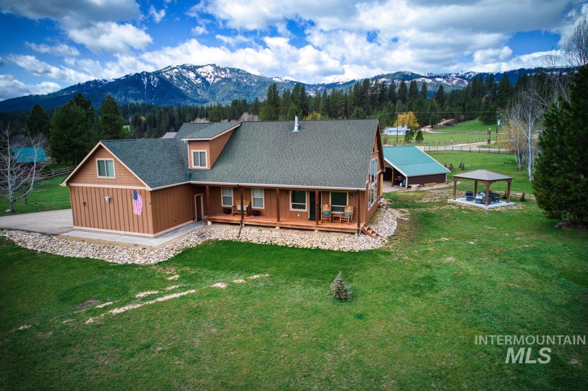 3 Boone Road Garden Valley, ID 83622 - Photo 2 of 49 Expansive residence with a covered porch, wood siding, multiple dormer windows, and a detached outbuilding