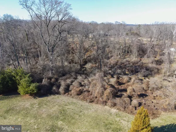 a view of a dining room and livingroom with furniture wooden floor a chandelier