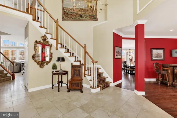 a dining room with furniture a chandelier and wooden floor