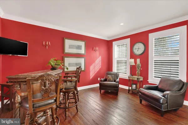 a kitchen with stainless steel appliances granite countertop a table chairs and a refrigerator