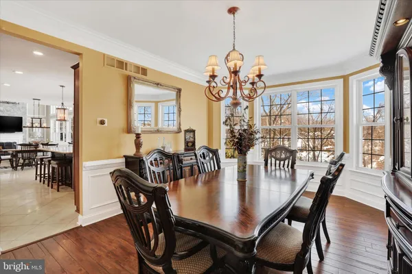 a view of a roof deck with table and chairs under an umbrella with wooden floor
