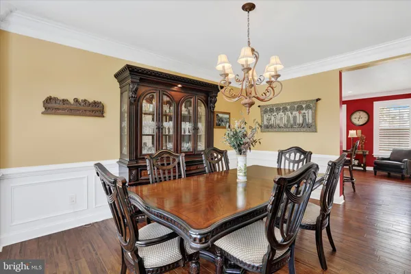 a view of a roof deck with table and chairs under an umbrella with wooden floor