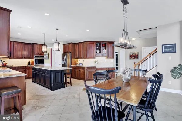 a view of a roof deck with table and chairs under an umbrella with wooden floor