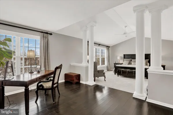 a view of a swimming pool with lawn chairs and a fire pit