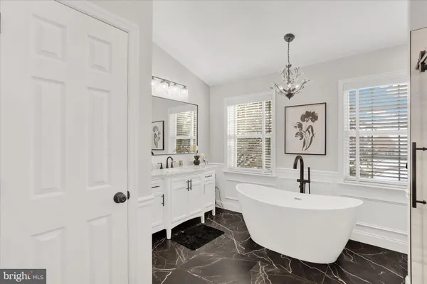 a view of a patio with table and chairs with wooden fence