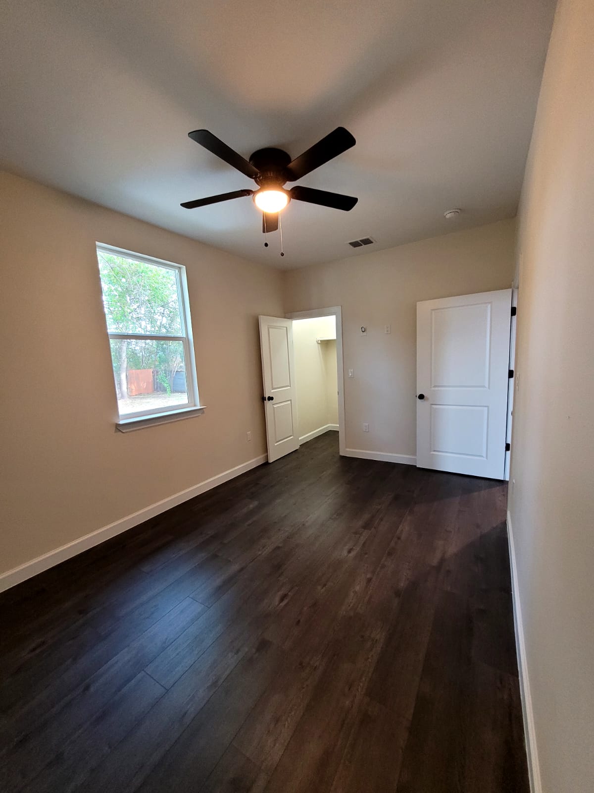 750 South Main Street Lockhart, TX 78644 - Photo 17 of 31 a view of an empty room with wooden floor and a window