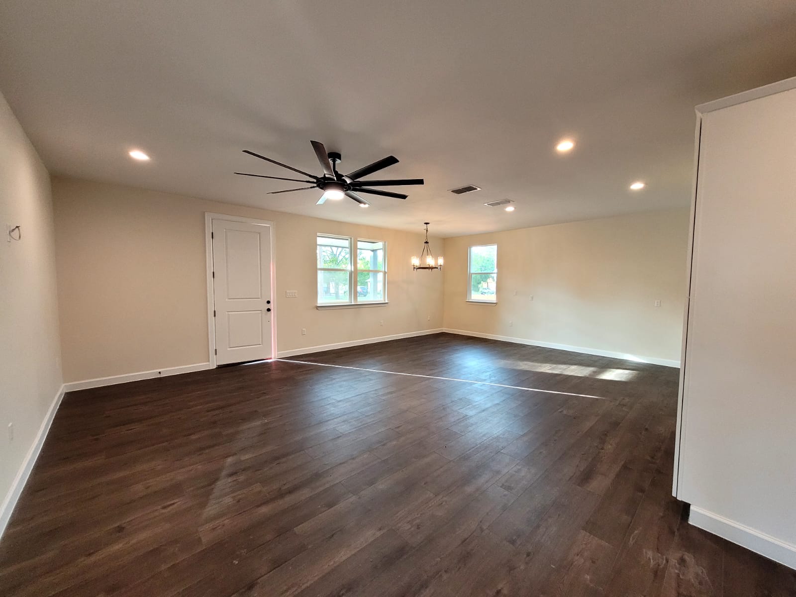 750 South Main Street Lockhart, TX 78644 - Photo 5 of 31 a view of empty room with wooden floor and fan