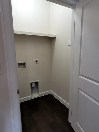 a room with a wooden floor and a window