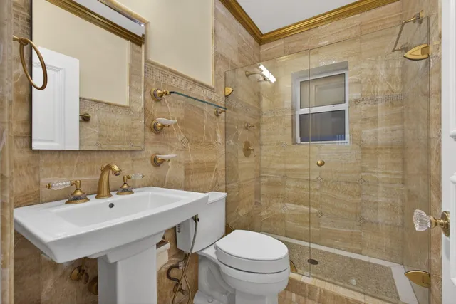 a kitchen with stainless steel appliances granite countertop a sink a stove and a refrigerator