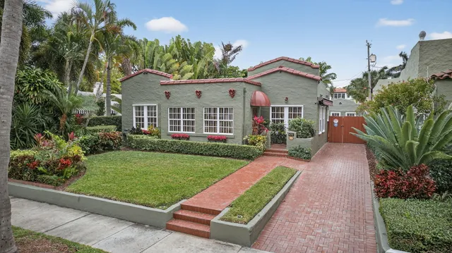 an aerial view of a house with a yard and trees