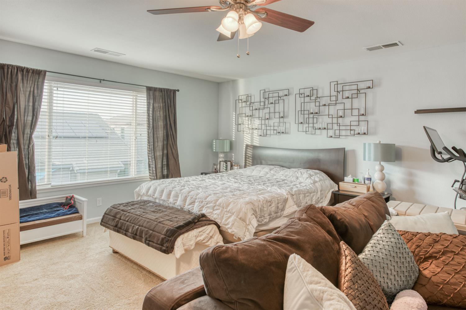 677 Everglade Avenue Clovis, CA 93619 - Photo 25 of 29 a bedroom with a large bed and a couch