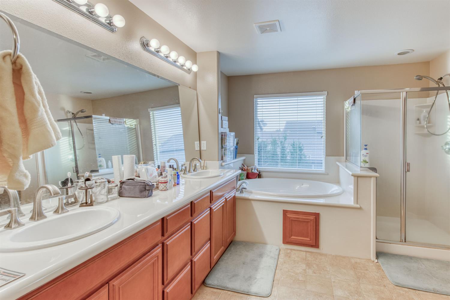 677 Everglade Avenue Clovis, CA 93619 - Photo 26 of 29 a bathroom with a tub sink and mirror