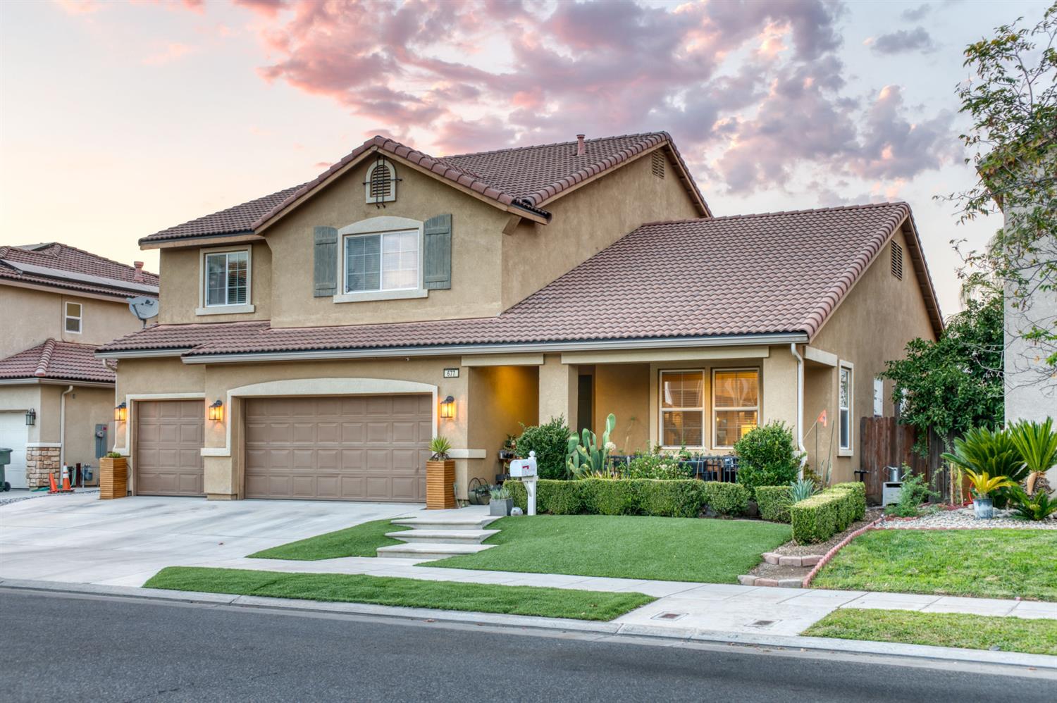 677 Everglade Avenue Clovis, CA 93619 - Photo 29 of 29 a front view of a house with a yard and garage
