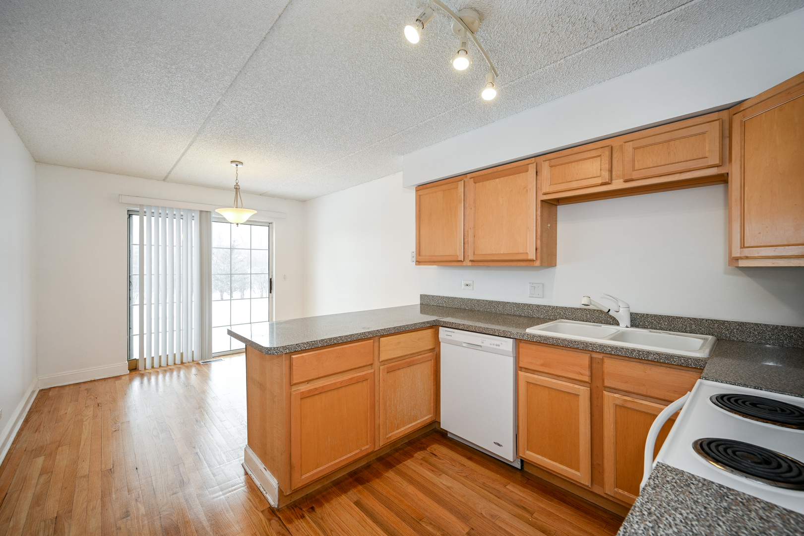 1348 South Lorraine Road, Unit A Wheaton, IL 60189 - Photo 6 of 21 a kitchen with a stove a sink and wooden floor