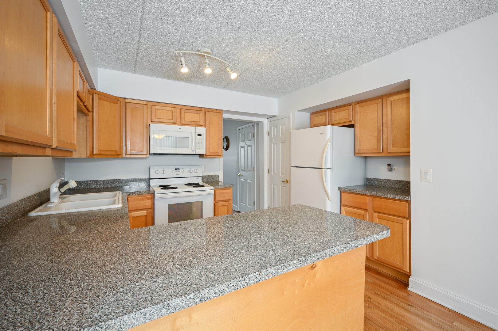 1348 South Lorraine Road, Unit A Wheaton, IL 60189 - Photo 7 of 21 a kitchen with stainless steel appliances granite countertop a sink stove and refrigerator