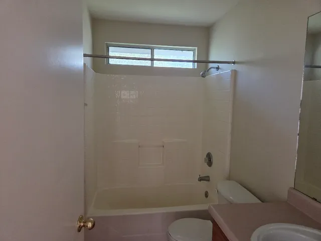 a bathroom with a shower and toilet