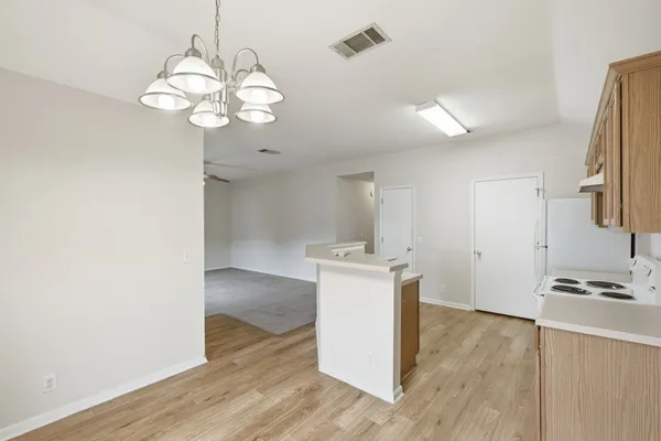 a view of kitchen with cabinets and wooden floor