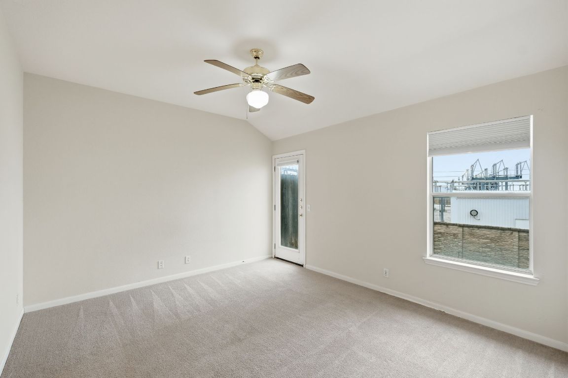 3201 E El Salido Parkway, Unit 422 Cedar Park, TX 78613 - Photo 9 of 15 Spare room featuring light colored carpet, healthy amount of natural light, ceiling fan, and vaulted ceiling