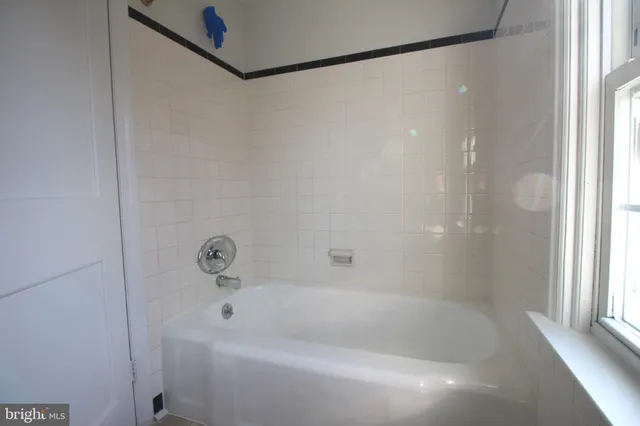 a white bath tub with a shower