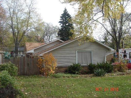 160 North Pinecrest Road Bolingbrook, IL 60440 - Photo 3 of 12 a view of a backyard with plants and a large tree