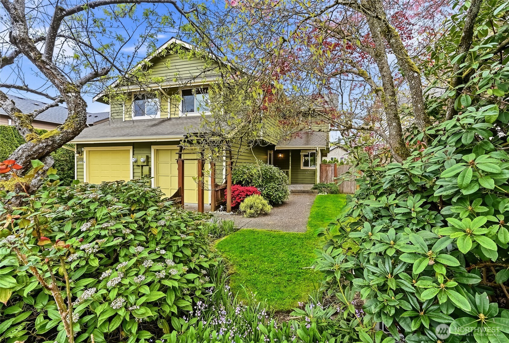 2120 185th Place Southeast Bothell, WA 98012 - Photo 1 of 30 a view of a white house with large windows and a tree