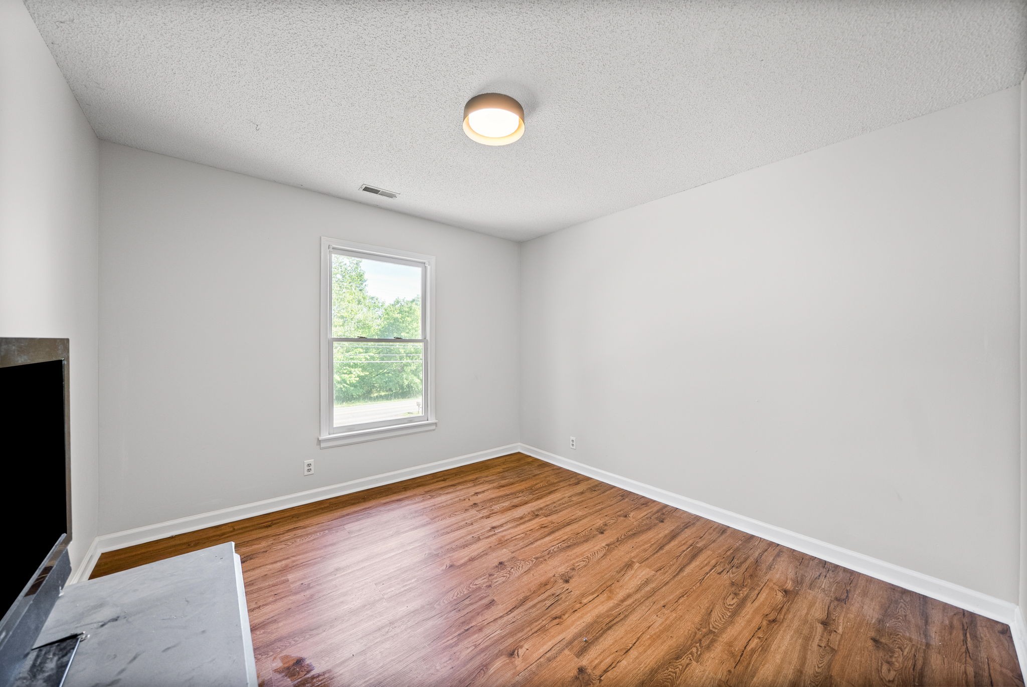 1706 Hazelwood Road Clarksville, TN 37042 - Photo 21 of 31 an empty room with wooden floor and windows