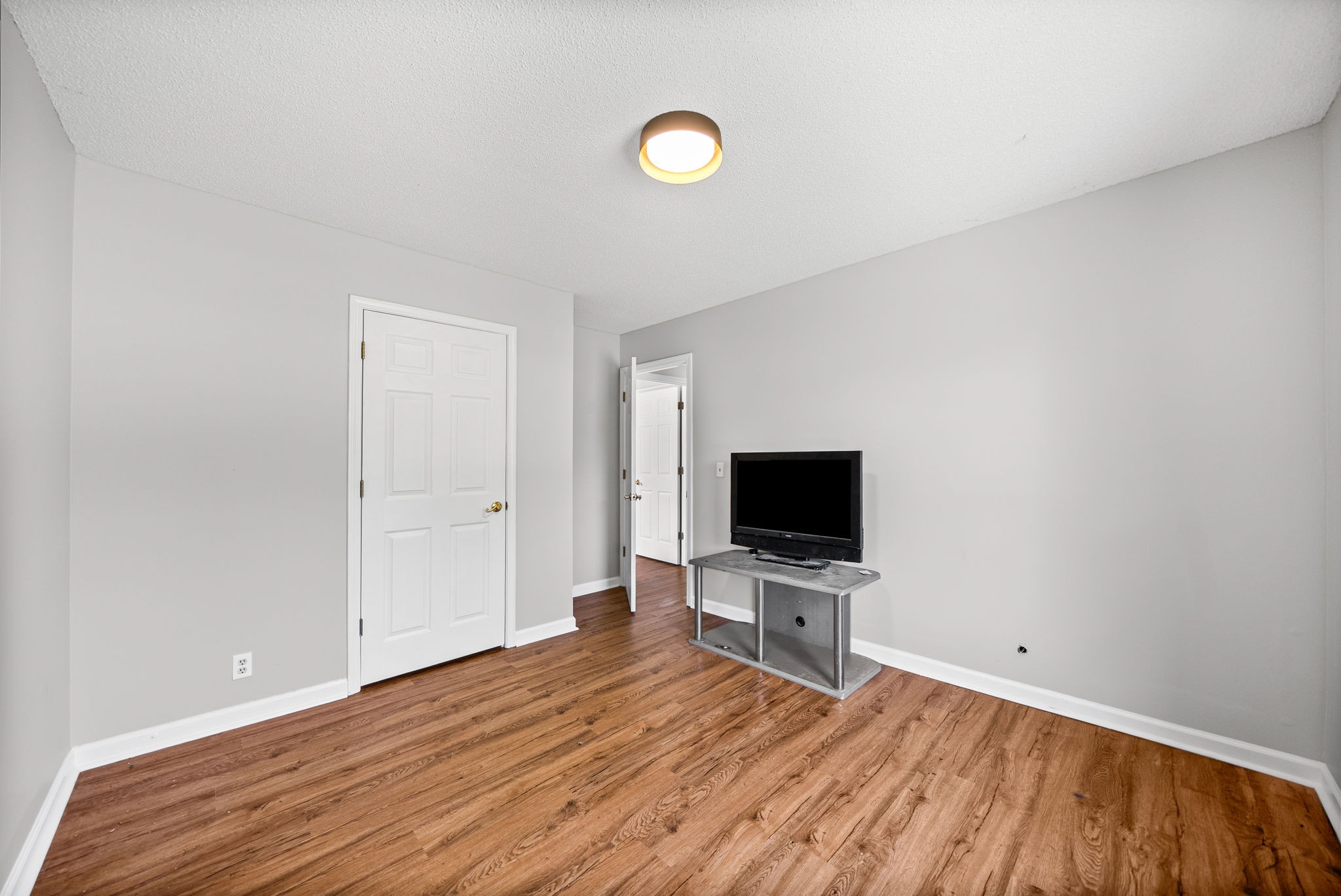1706 Hazelwood Road Clarksville, TN 37042 - Photo 22 of 31 a view of a room with wooden floor and flat screen tv
