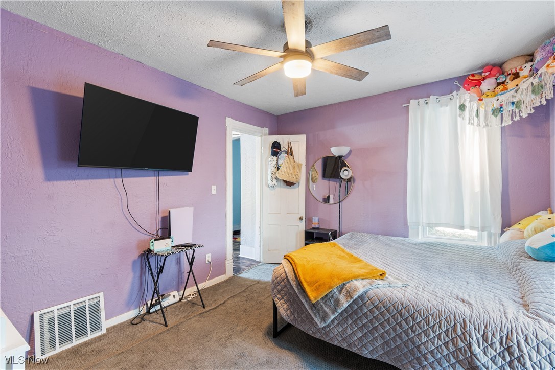 736 Wooster Road North Barberton, OH 44203 - Photo 16 of 31 Carpeted bedroom with a textured ceiling and ceiling fan