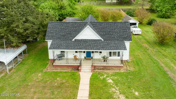 an aerial view of a house with a garden and swimming pool
