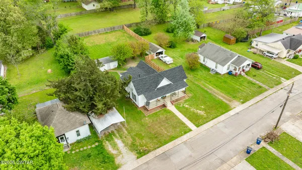 a front view of a house with a yard deck and patio