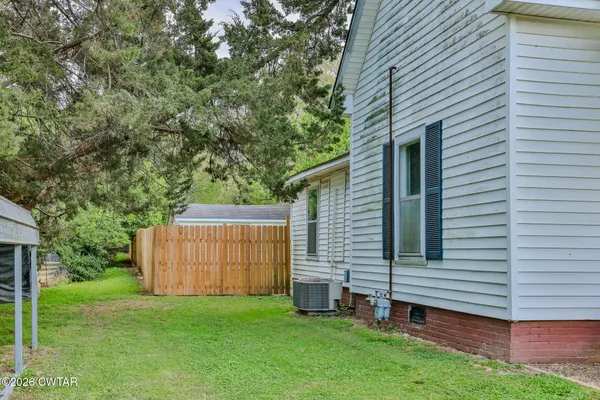a view of a backyard with a large tree
