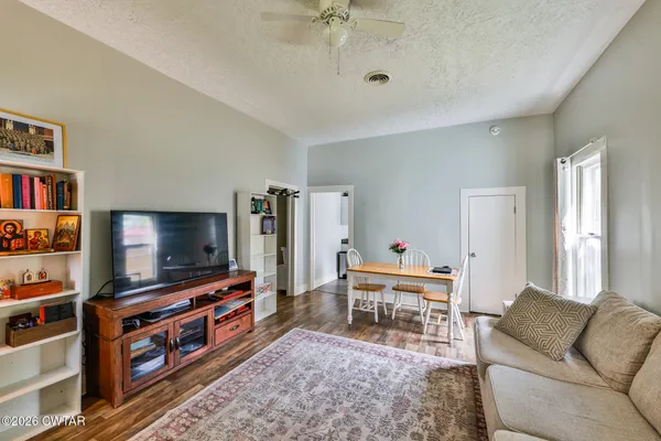 a living room with furniture and a chandelier