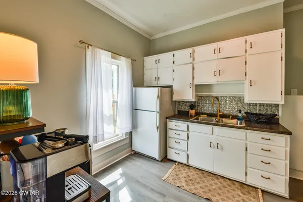 a kitchen with a sink a stove and cabinets