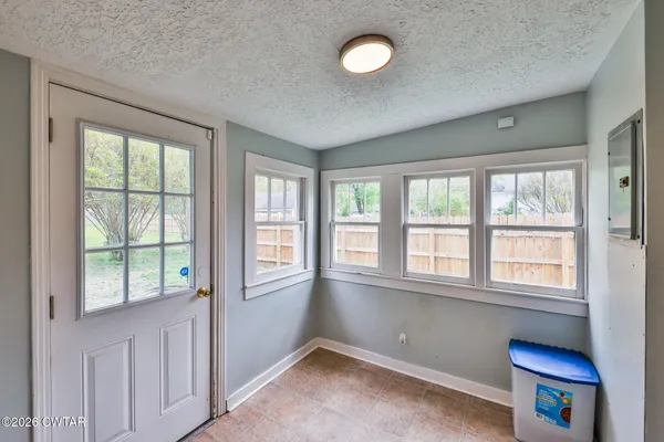 a view of a room with an entryway and wooden floor